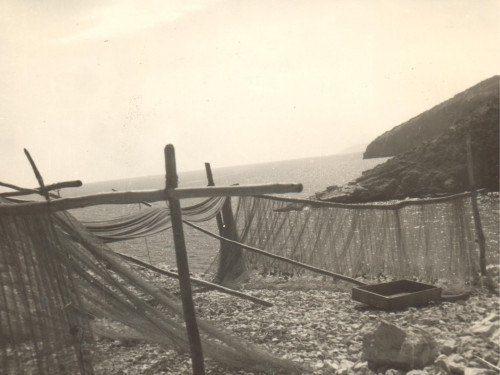 Net dryers above little port and on a beach in Brseč
